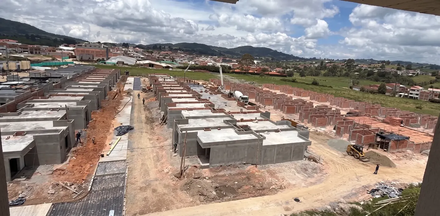 Panorámica de la obra de Los Sauces Etapa 2: casas con placa terminada, bomba de concreto y mampostería en curso
